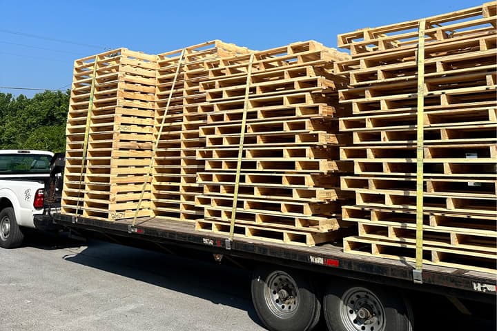 Large load of pallets on trailer with truck helping to streamline operations as part of IPCS Onsite Inventory Management
